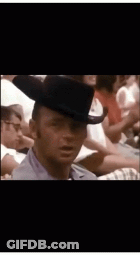 Man In Cowboy Hat Sitting In Crowd GIF