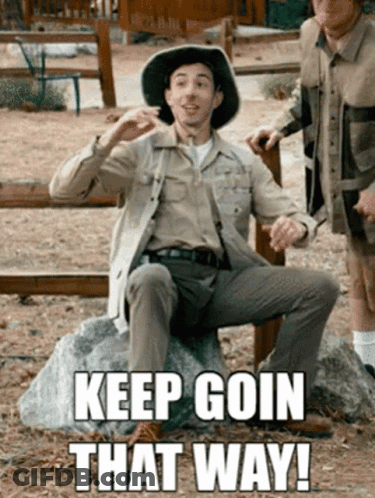 Man In Cowboy Hat Sitting On Rock Saying Keep Goin That Way GIF