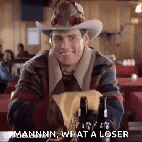 Man In Cowboy Hat Sitting With Beer Bottles GIF