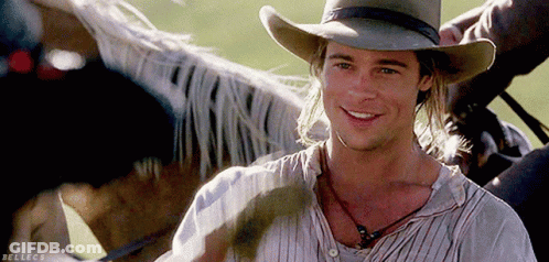 Man In Cowboy Hat Smiling Next To Horse GIF