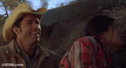 Man In Cowboy Hat Smiling Next To Woman GIF