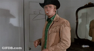 Man In Cowboy Hat Smoking Cigarette In Mirror GIF