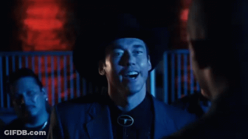 Man In Cowboy Hat Standing Before Home Sign GIF