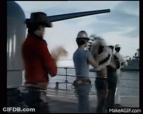 Man In Cowboy Hat Standing Next To Men On Boat GIF