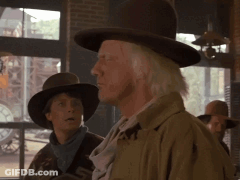 Man In Cowboy Hat Standing Next To Woman GIF