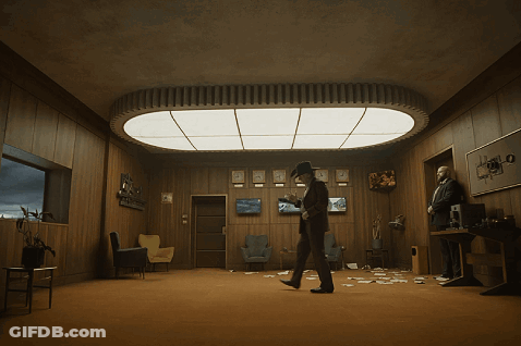 Man In Cowboy Hat Under Ceiling Light GIF