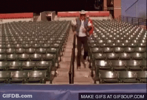 Man In Cowboy Hat Walking Down Stadium Stairs GIF