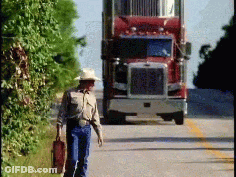 Man In Cowboy Hat Walking In Front Of Red Semi Truck GIF