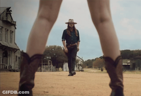 Man In Cowboy Hat Walking With Woman In Cowboy Boots GIF
