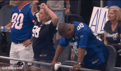 Man In Cowboy Jersey Wipes Face GIF