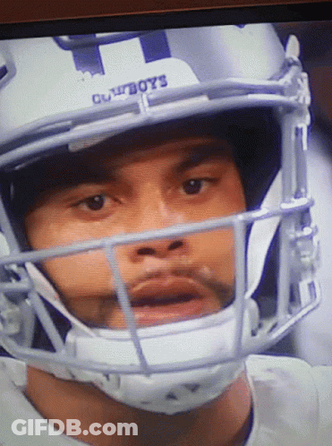 Man In Cowboys Football Helmet Looking At Camera GIF