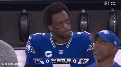 Man In Cowboys Jersey Looking At Scoreboard GIF