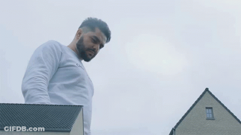 Man In Creator Galaxy Sweatshirt In Front Of House GIF