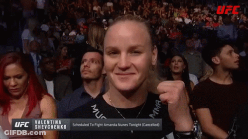 Man In Crowd Holding Valentina Shevchenko Sign GIF
