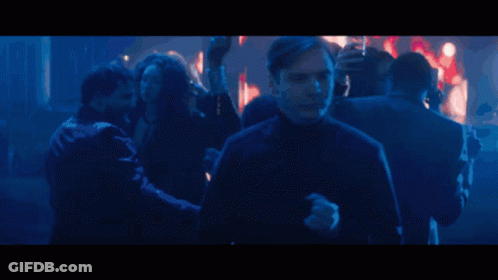 Man In Crowd In Dark Room GIF