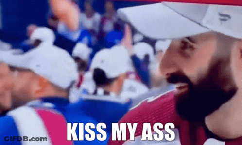 Man In Crowd With Kiss My Ass Shirt GIF