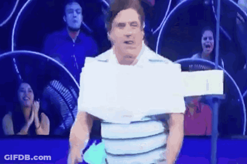 Man In Crowd With Paper On Shirt GIF
