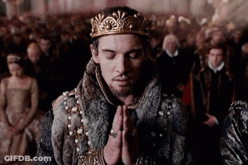 Man In Crown And Fur Coat Praying Before Crowd GIF