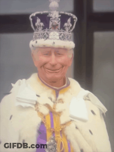 Man In Crown And Purple Robe Smiling GIF