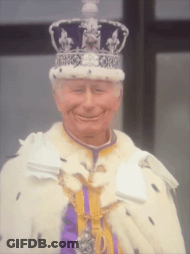 Man In Crown And Purple Robe Smiling GIF