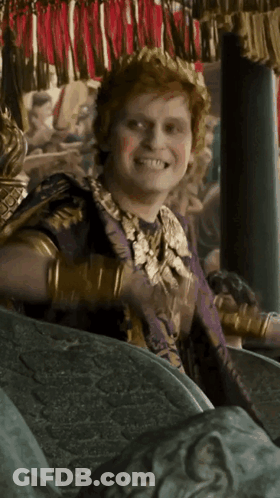 Man In Crown And Purple Robe Smiling GIF