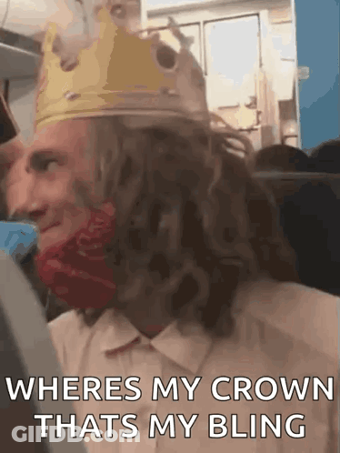 Man In Crown And Red Bandana On A Plane GIF