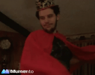 Man In Crown And Red Cape Smiling GIF