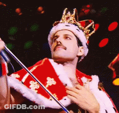 Man In Crown And Red Robe Holding Microphone GIF