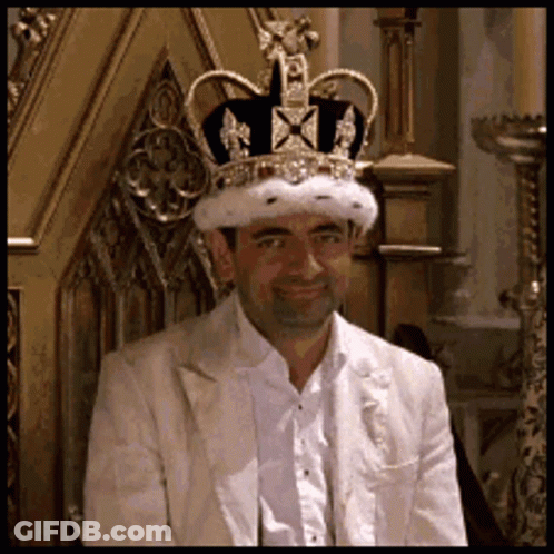 Man In Crown And White Suit On Throne GIF