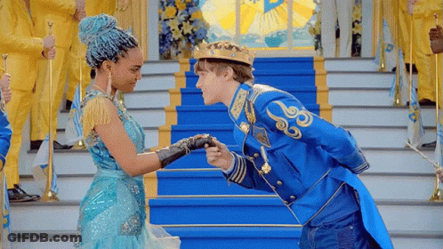 Man In Crown Kissing Woman In Blue Dress GIF