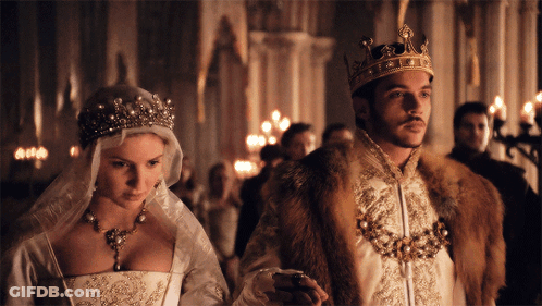Man In Crown Next To Woman In Wedding Dress GIF
