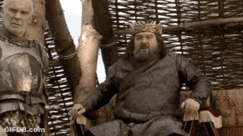 Man In Crown Sitting Next To Another Man GIF