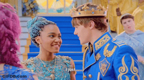 Man In Crown Talking To Woman In Blue Dress GIF
