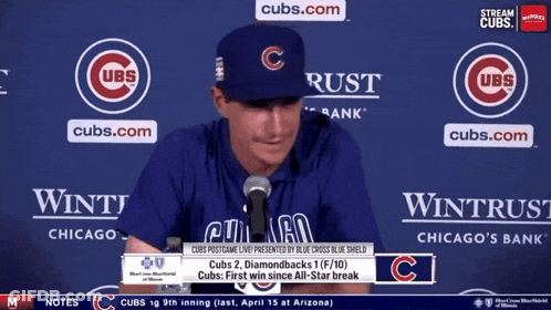 Man In Cubs Hat Sitting At Microphone GIF