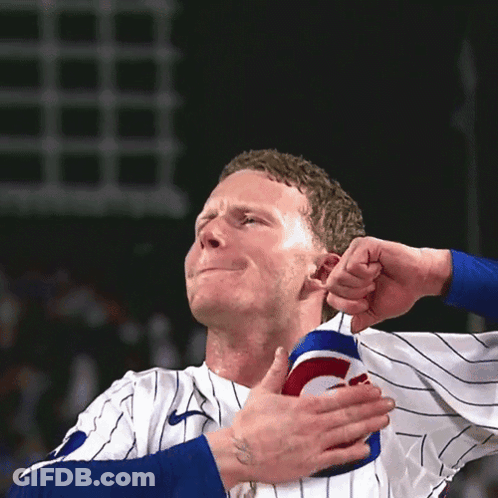 Man In Cubs Jersey Holding Shoulder GIF