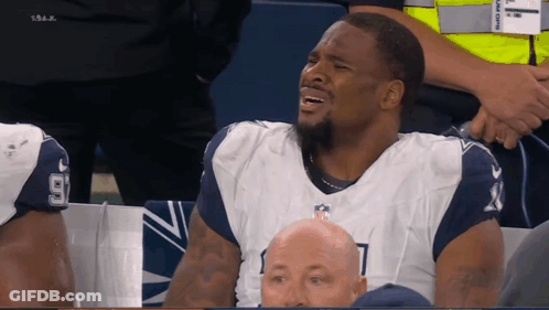 Man In Dallas Cowboys Uniform Sitting In Stands GIF