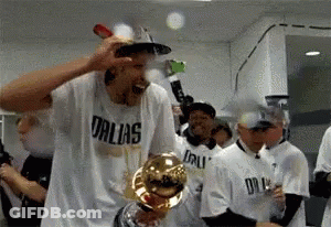 Man In Dallas Shirt Holding Trophy GIF