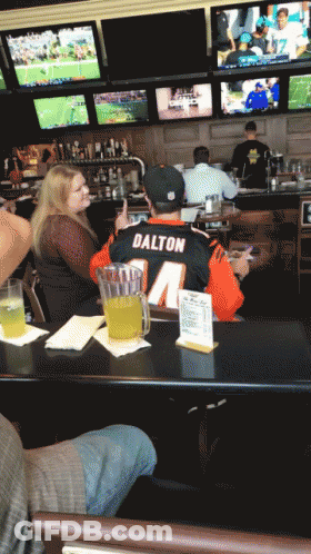 Man In Dalton Jersey Sitting At Table GIF