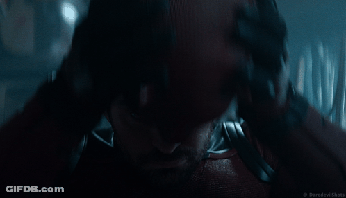 Man In Daredevil Costume Holding Head GIF