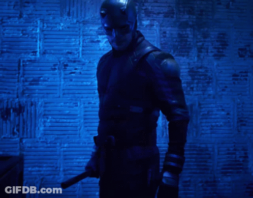 Man In Daredevil Costume Holding Knife GIF