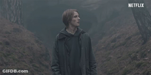Man In Dark Forest With Netflix Logo GIF