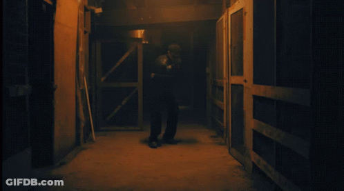 Man In Dark Hallway Wearing Skeletons Shirt GIF