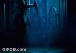 Man In Dark Room Holding Sword GIF
