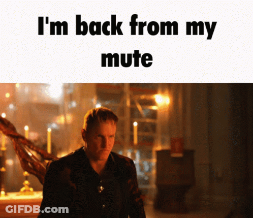 Man In Dark Room Saying I'm Back From My Mute GIF