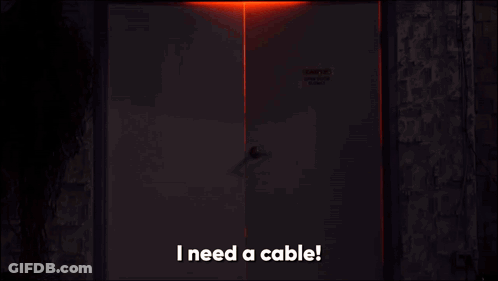 Man In Dark Room Saying I Need A Cable GIF