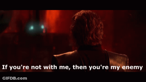 Man In Dark Room Saying If You're Not With Me Then You're My Enemy GIF