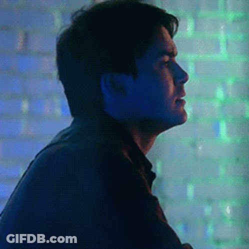 Man In Dark Room With Blue And Green Lights GIF