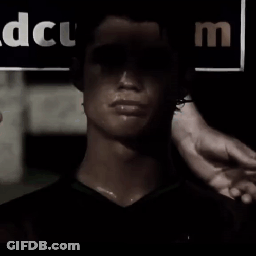 Man In Dark Room With DCUM Sign GIF