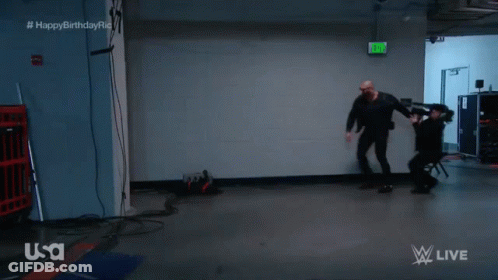Man In Dark Room With Green Exit Sign GIF