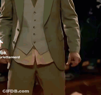 Man In Dark Room With Green Glove GIF